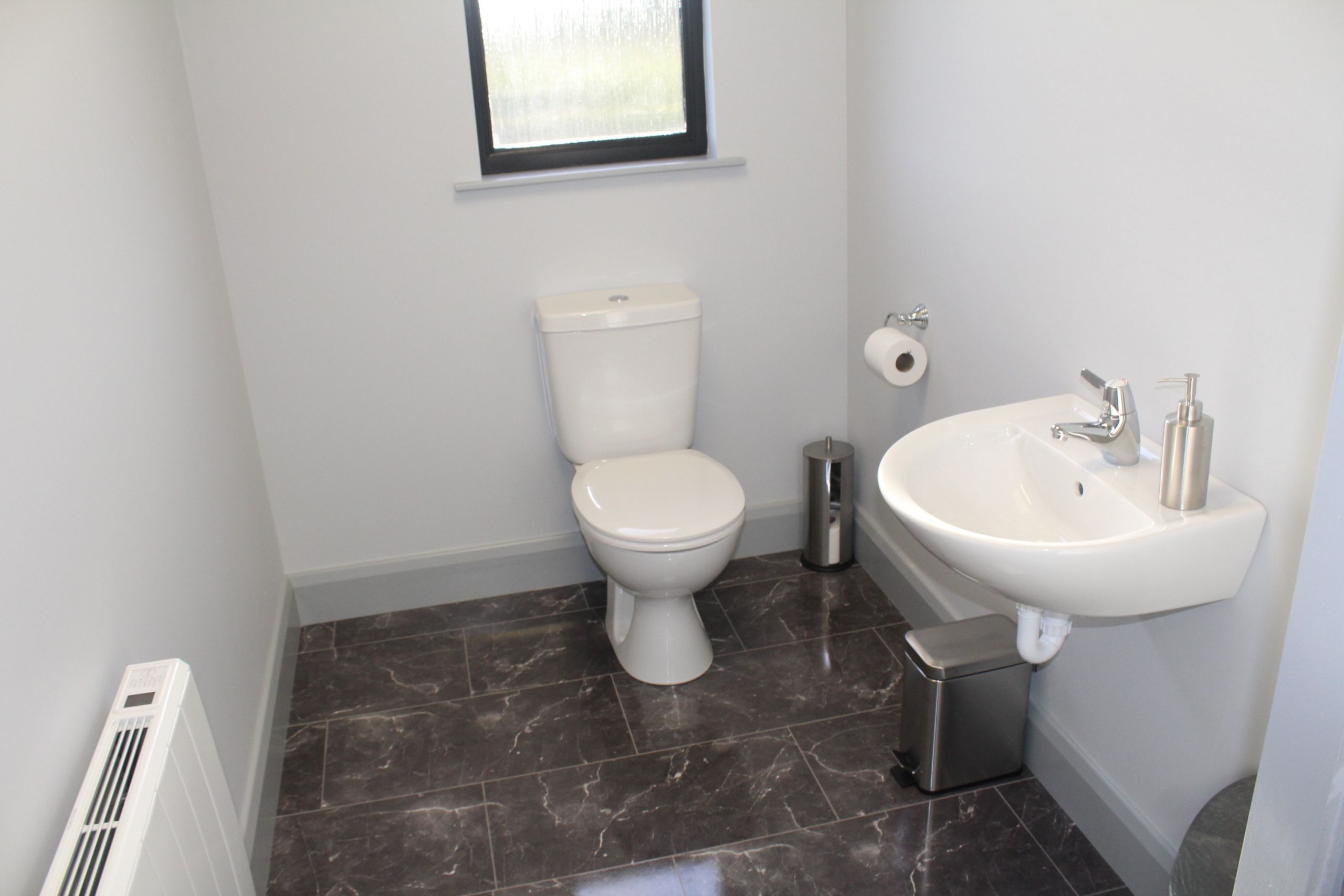 Modular office space white bathroom with grey tiles