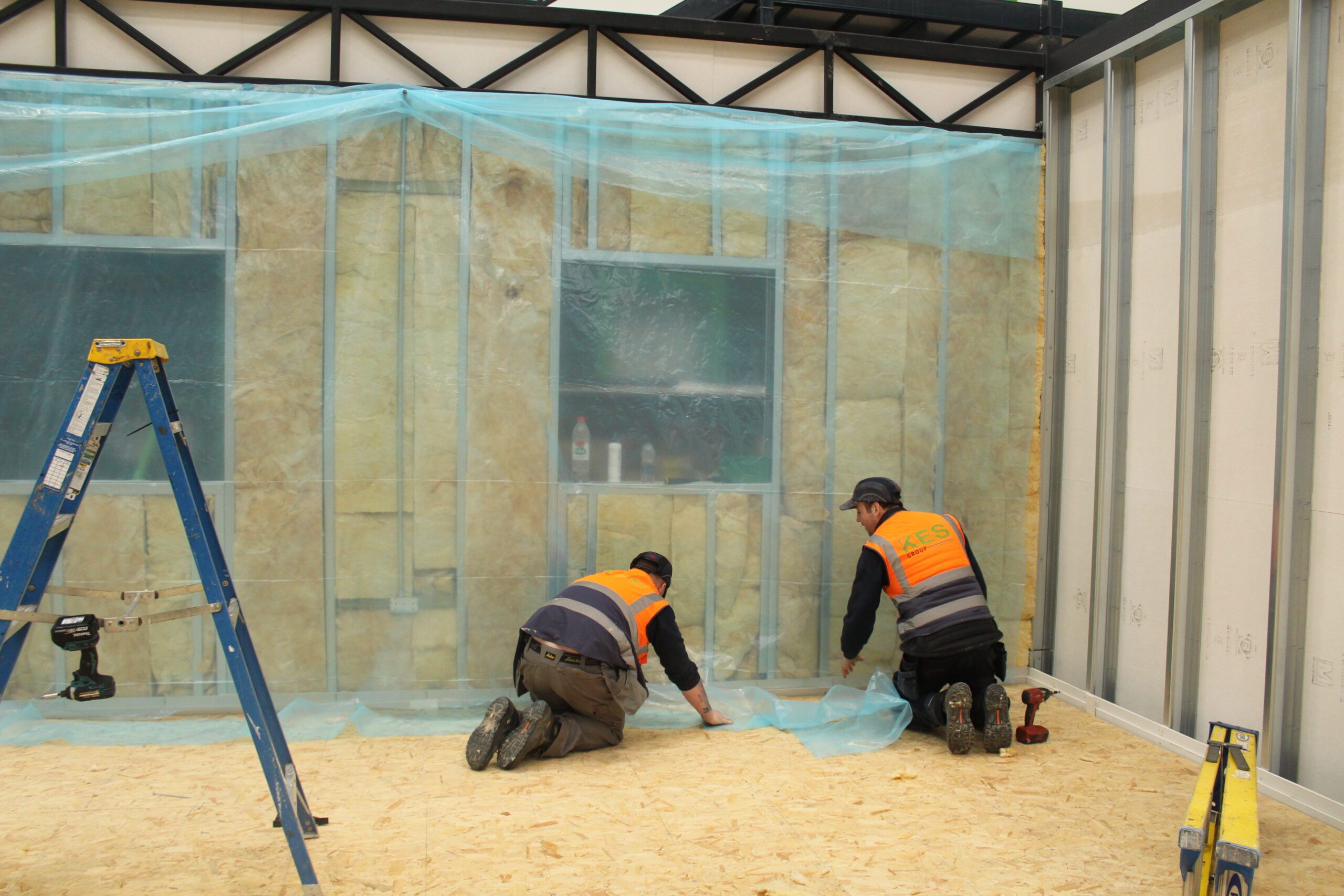 men working on the ground of modular building 