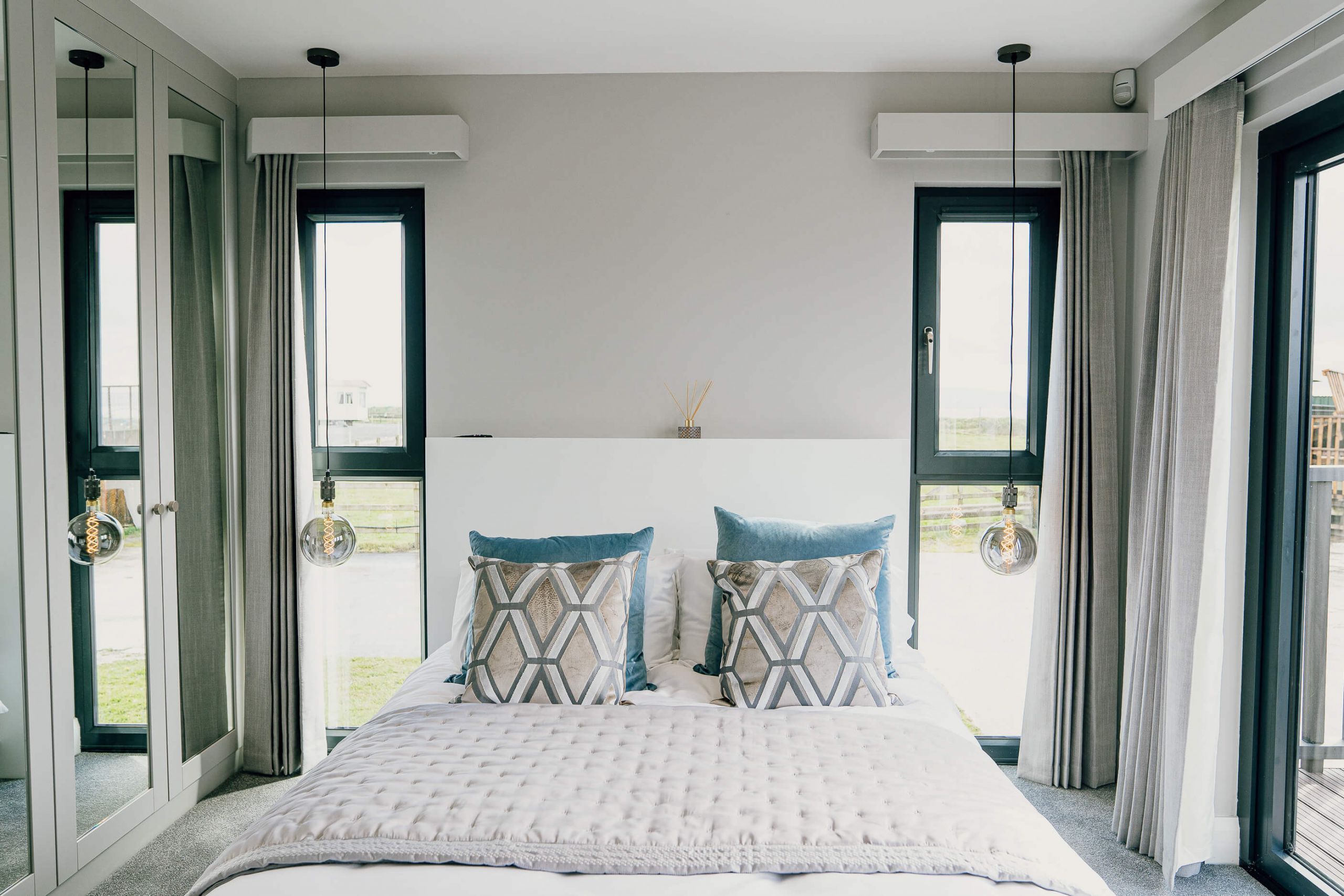 KES Group double bedroom turnkey home luxury lights windows cushions